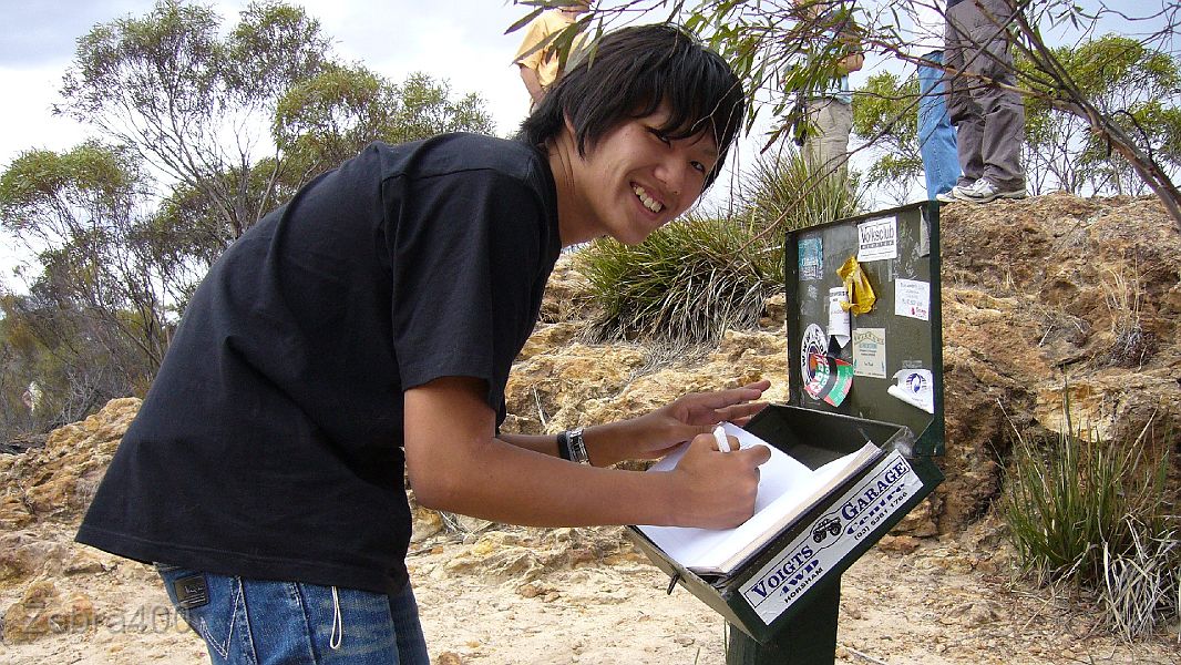 26-Japanese exchange student (Hiroaki) signs the visitors book at Milmed Rock.JPG